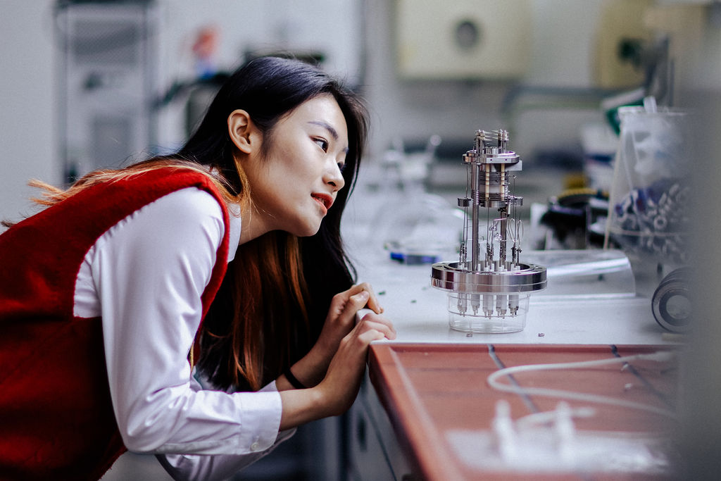 A person in a laboratory inspects an instrument. Photo: Anne Schwerin